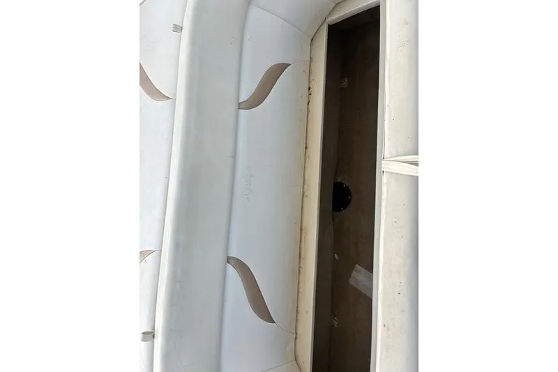 Slide: The Image of 1999 Ebbtide 2300 boat interior with white and beige seating. - 34