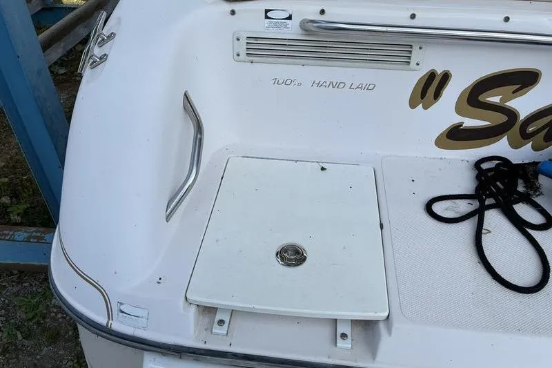 Slide: The Image of 1999 Ebbtide 2300 boat stern with hand-laid fiberglass and storage hatch. - 42