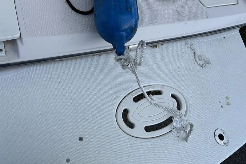 Slide: The Image of 1999 Ebbtide 2300 boat deck with blue fender and rope attachment. - 44