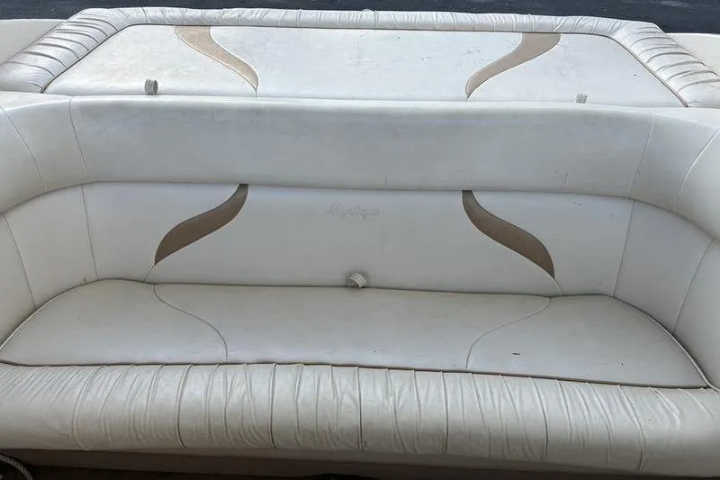 Slide: The Image of 1999 Ebbtide 2300 boat interior seating with white upholstery and stylish design. - 9
