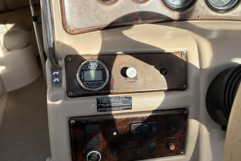 Slide: The Image of 1999 Ebbtide 2300 boat dashboard with gauges and controls in sunlight. - 27