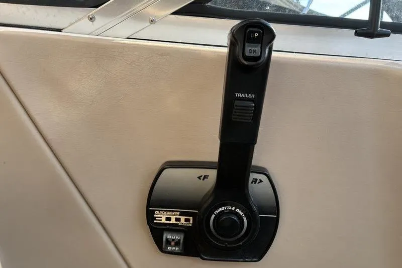 Slide: The Image of Throttle control lever on a 1999 Ebbtide 2300 boat dashboard. - 30