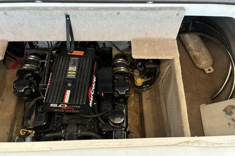 Slide: The Image of 1999 Ebbtide 2300 boat engine compartment with MerCruiser 5.0L engine. - 37