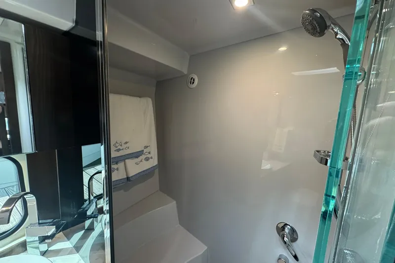 Slide: The Image of Luxurious bathroom in 2022 Cruisers Yachts 390 Express Coupe with modern shower fixtures. - 11