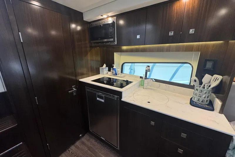 Slide: The Image of Luxurious kitchen interior of 2022 Cruisers Yachts 390 Express Coupe with modern amenities. - 13