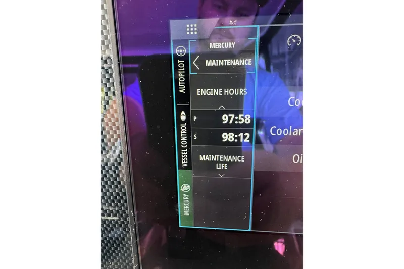 Slide: The Image of Display screen showing engine hours on 2022 Cruisers Yachts 390 Express Coupe. - 14
