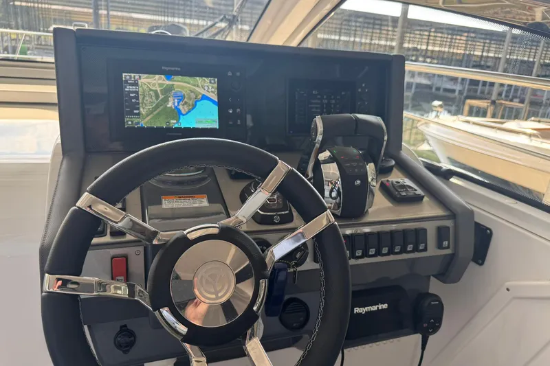 Slide: The Image of 2022 Cruisers Yachts 390 Express Coupe helm with navigation display and controls. - 15