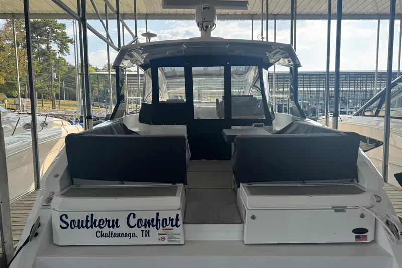 Slide: The Image of 2022 Cruisers Yachts 390 Express Coupe docked, rear view, "Southern Comfort" name visible. - 3