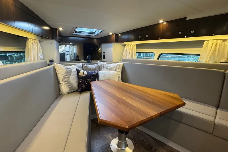 Slide: The Image of Luxurious interior of 2022 Cruisers Yachts 390 Express Coupe with elegant seating and wooden table. - 6