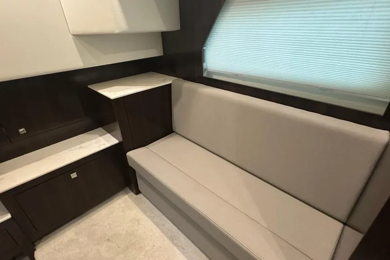 Slide: The Image of Interior of 2022 Cruisers Yachts 390 Express Coupe with beige seating and modern cabinetry. - 8