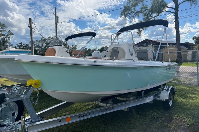 The Image of 2026 Key West 1720 Center Console boat on trailer, parked outdoors under a cloudy sky. - 0