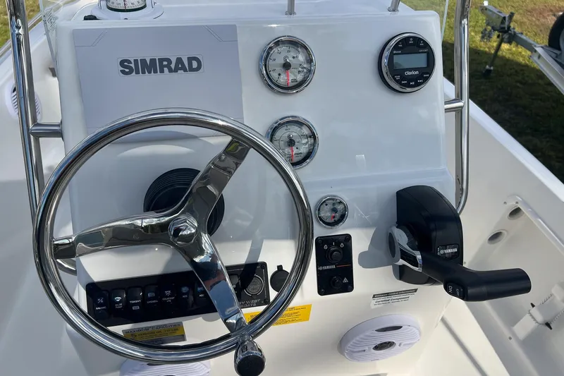 Slide: The Image of 2026 Key West 1720 Center Console boat dashboard with steering wheel and controls. - 10