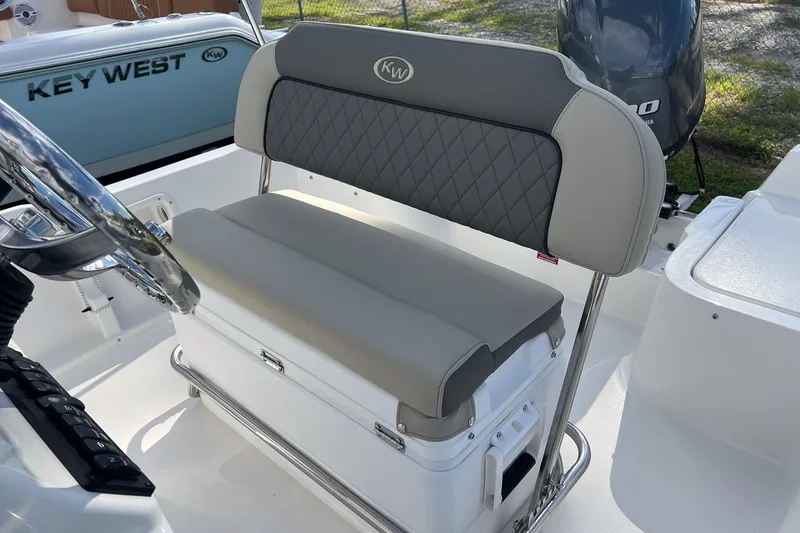 Slide: The Image of 2026 Key West 1720 Center Console boat interior with cushioned seating and steering wheel. - 13