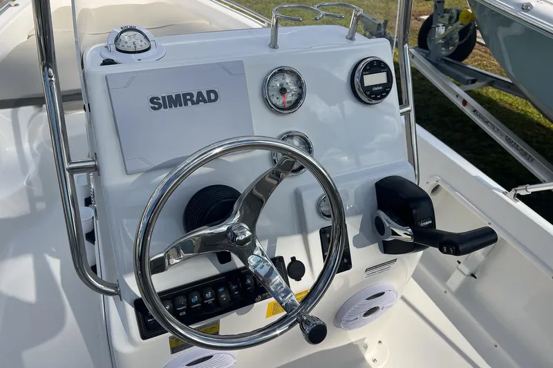 Slide: The Image of 2026 Key West 1720 Center Console boat dashboard with steering wheel and Simrad electronics. - 9