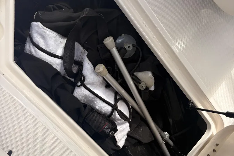 Slide: The Image of Storage compartment in a 2011 Monterey 204FS boat with equipment and accessories. - 22