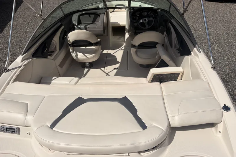 Slide: The Image of 2011 Monterey 204FS boat interior with white seating and steering wheel. - 29