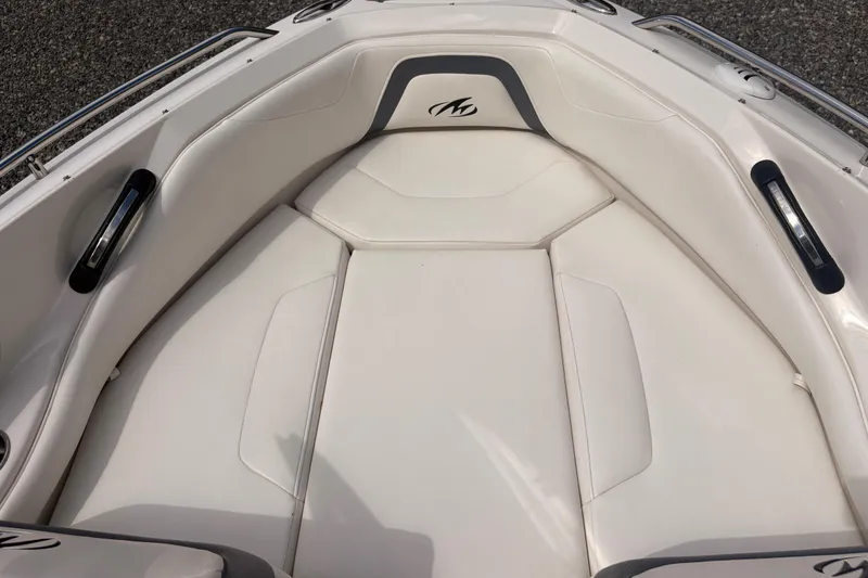 Slide: The Image of 2011 Monterey 204FS boat interior with white cushioned seating and sleek design. - 33