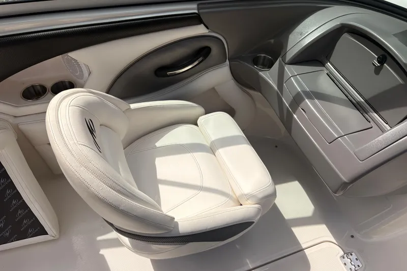 Slide: The Image of 2011 Monterey 204FS boat interior with white seating and dashboard. - 35