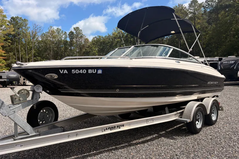 The Image of 2011 Monterey 204FS boat on trailer, parked outdoors with trees in background. - 5
