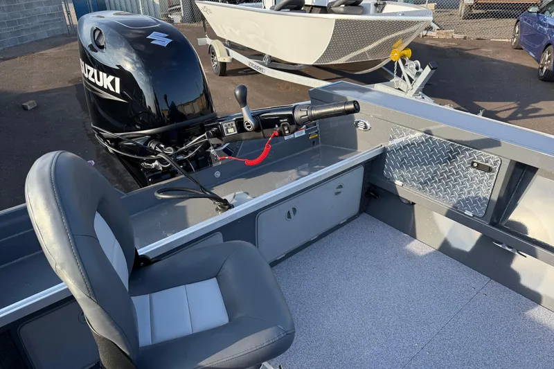 Slide: The Image of 2026 Fish Rite River Master 18 boat interior with Suzuki outboard motor. - 11