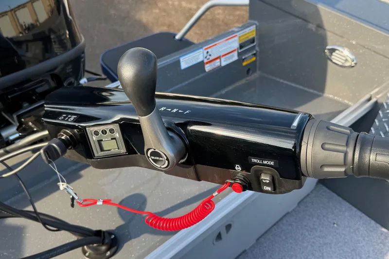 Slide: The Image of Close-up of 2026 Fish Rite River Master 18 boat controls with Suzuki throttle. - 12