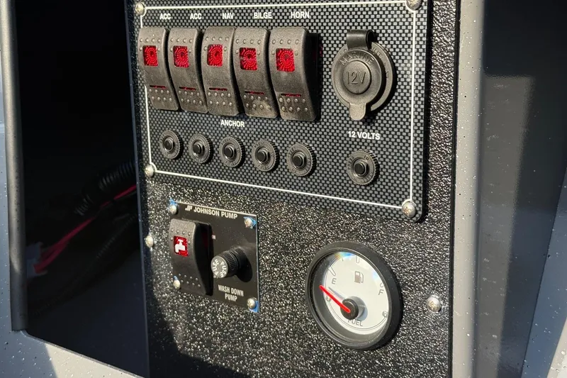 Slide: The Image of Control panel of 2026 Fish Rite River Master 18 boat with switches and fuel gauge. - 14