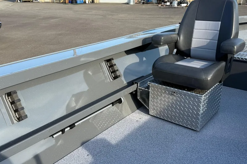 Slide: The Image of 2026 Fish Rite River Master 18 boat interior with cushioned seat and diamond plate storage box. - 15