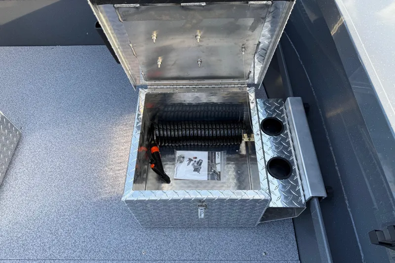 Slide: The Image of Open storage compartment in 2026 Fish Rite River Master 18 boat, featuring diamond plate design. - 17