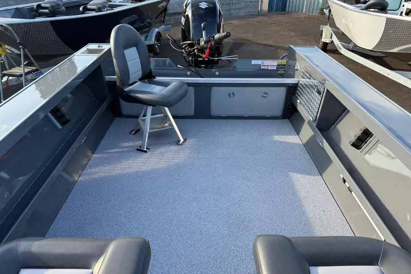 Slide: The Image of 2026 Fish Rite River Master 18 boat interior with seating and motor, showcasing spacious design. - 18