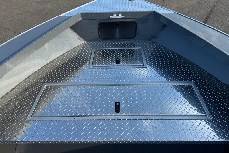 Slide: The Image of 2026 Fish Rite River Master 18 boat with diamond plate flooring and storage compartments. - 19