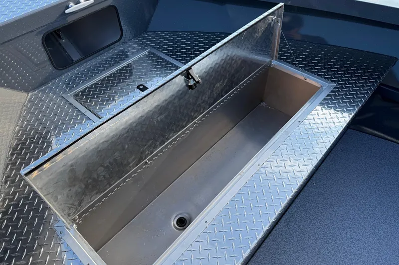 Slide: The Image of 2026 Fish Rite River Master 18 boat with open storage compartment on diamond plate deck. - 21