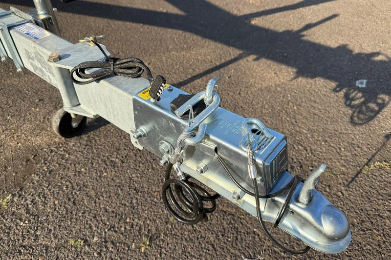 Slide: The Image of Trailer hitch of a 2026 Fish Rite River Master 18 on asphalt surface. - 24