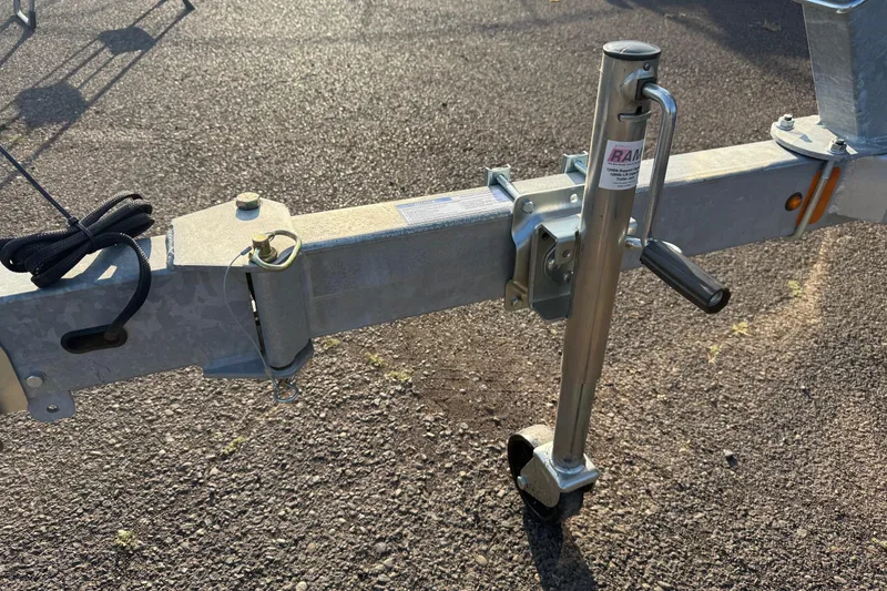 Slide: The Image of Trailer hitch and jack of 2026 Fish Rite River Master 18 on asphalt surface. - 25