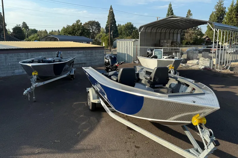 Slide: The Image of 2026 Fish Rite River Master 18 boats on trailers in outdoor storage area. - 27