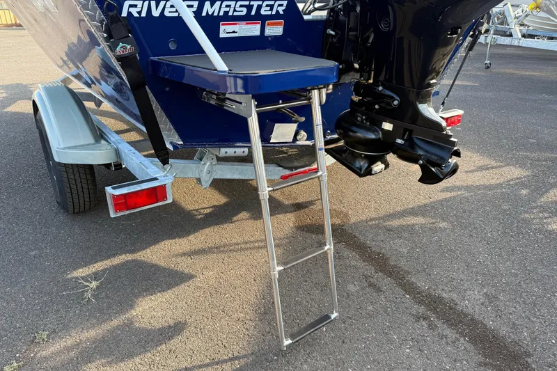 Slide: The Image of Rear view of 2026 Fish Rite River Master 18 boat with ladder and trailer. - 6