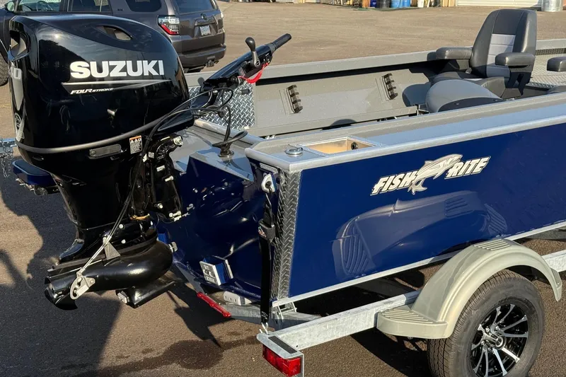 Slide: The Image of 2026 Fish Rite River Master 18 boat with Suzuki outboard motor on trailer. - 8