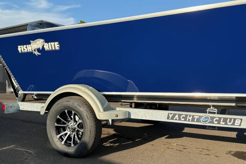 Slide: The Image of 2026 Fish Rite River Master 18 boat on Yacht Club trailer, blue exterior. - 9