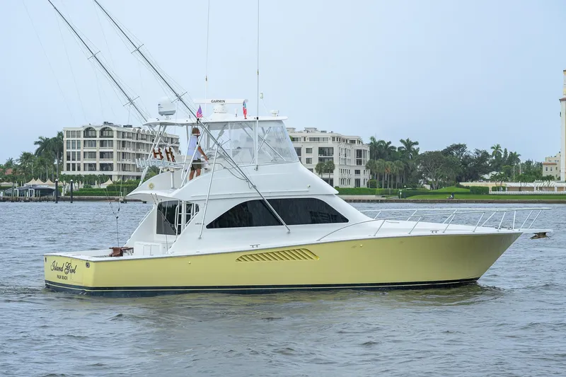 Slide: The Image of 2004 Viking 48 Convertible yacht on water, with buildings in the background. - 11