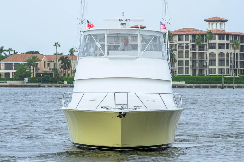 Slide: The Image of 2004 Viking 48 Convertible yacht on water, with waterfront buildings in the background. - 13