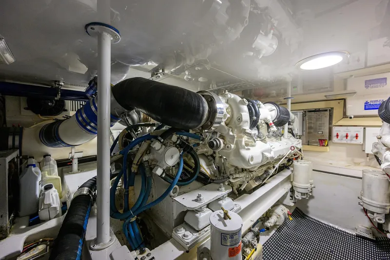 Slide: The Image of Engine room of a 2004 Viking 48 Convertible yacht, showcasing machinery and components. - 14