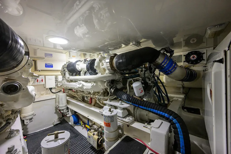 Slide: The Image of Engine room of a 2004 Viking 48 Convertible yacht, showcasing machinery and components. - 16