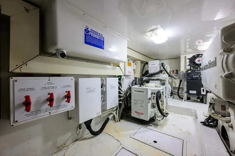 Slide: The Image of Engine room of 2004 Viking 48 Convertible yacht, featuring control panels and equipment. - 21