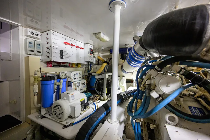 Slide: The Image of Engine room of 2004 Viking 48 Convertible yacht with complex machinery and control panels. - 22