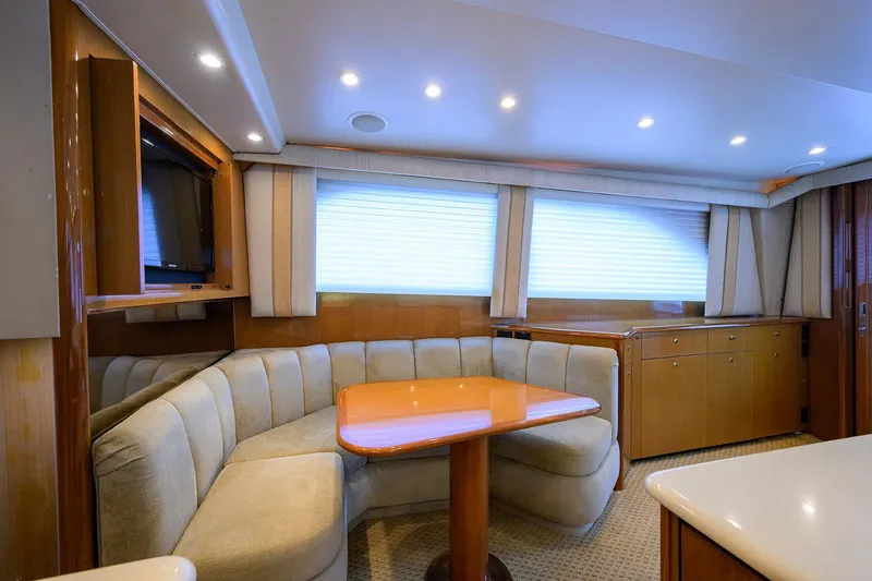 Slide: The Image of Luxurious interior of 2004 Viking 48 Convertible yacht with plush seating and wooden cabinetry. - 28