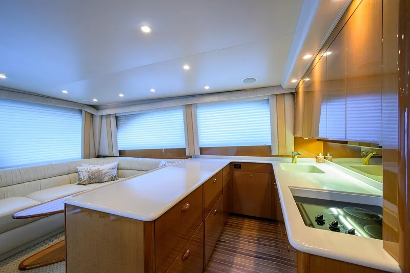Slide: The Image of Luxurious interior of a 2004 Viking 48 Convertible yacht with modern kitchen and seating area. - 32