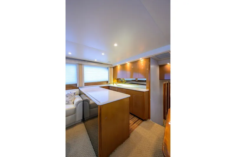 Slide: The Image of Luxurious interior of 2004 Viking 48 Convertible yacht with modern kitchen and seating area. - 36