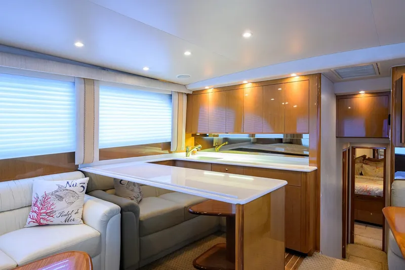 Slide: The Image of Luxurious interior of a 2004 Viking 48 Convertible yacht with modern furnishings and ambient lighting. - 37