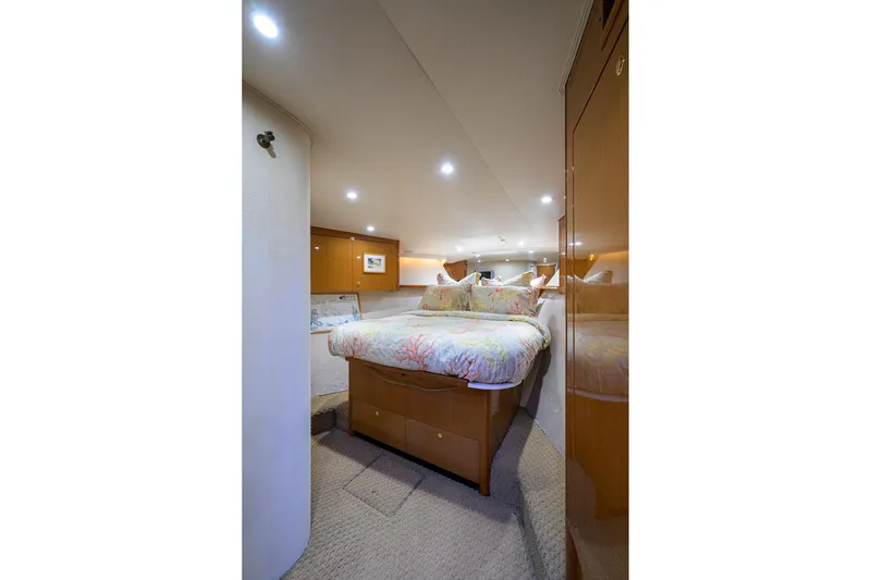 Slide: The Image of Luxurious bedroom interior of 2004 Viking 48 Convertible yacht with elegant wood finishes. - 38