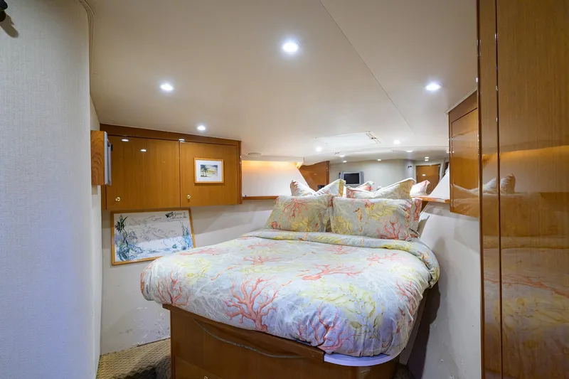 Slide: The Image of Luxurious bedroom interior of 2004 Viking 48 Convertible yacht with elegant bedding and wood cabinetry. - 39