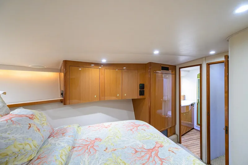 Slide: The Image of Luxurious cabin interior of 2004 Viking 48 Convertible yacht with wood cabinetry and cozy bedding. - 41